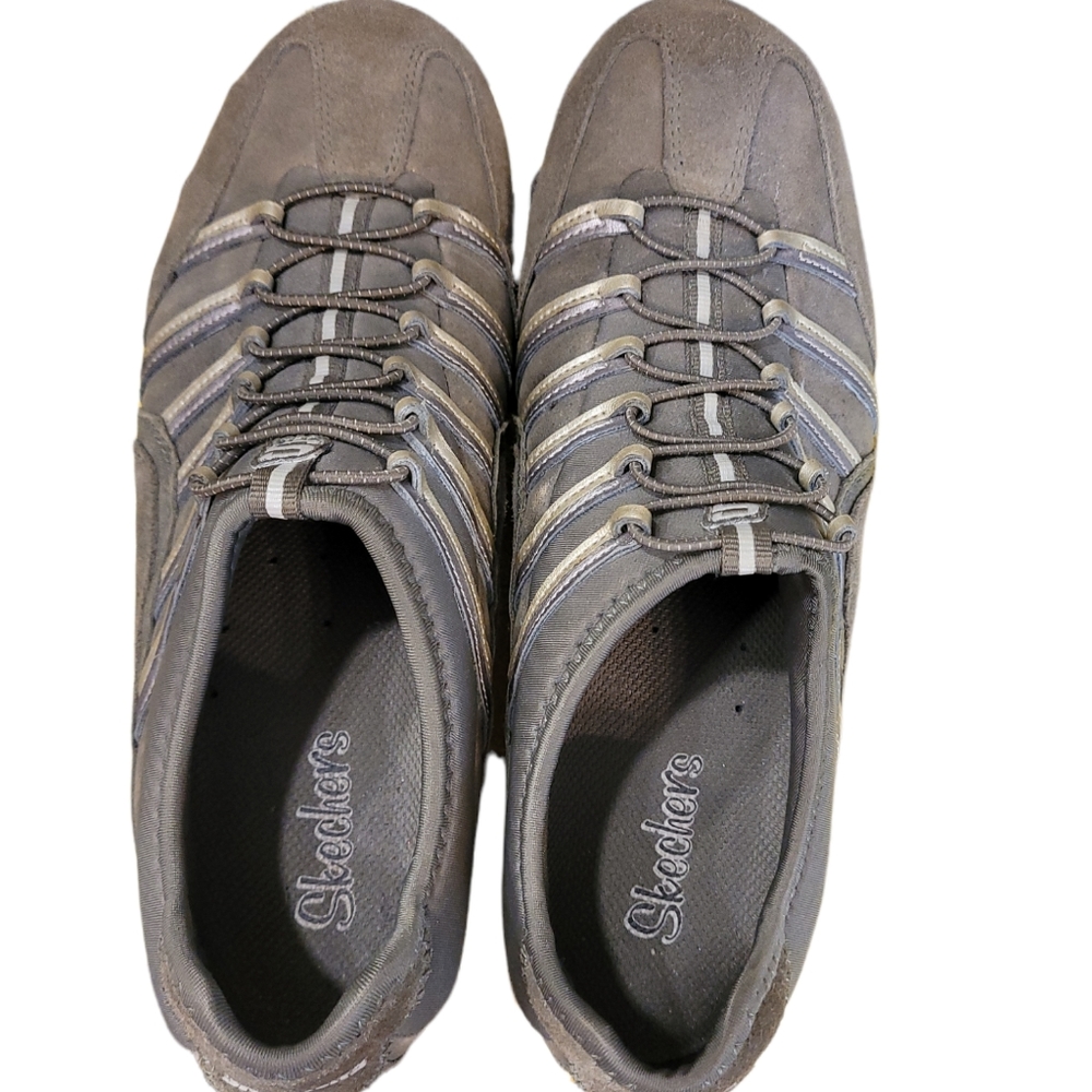 Skechers green outlined with gold ad gray. Slip on.